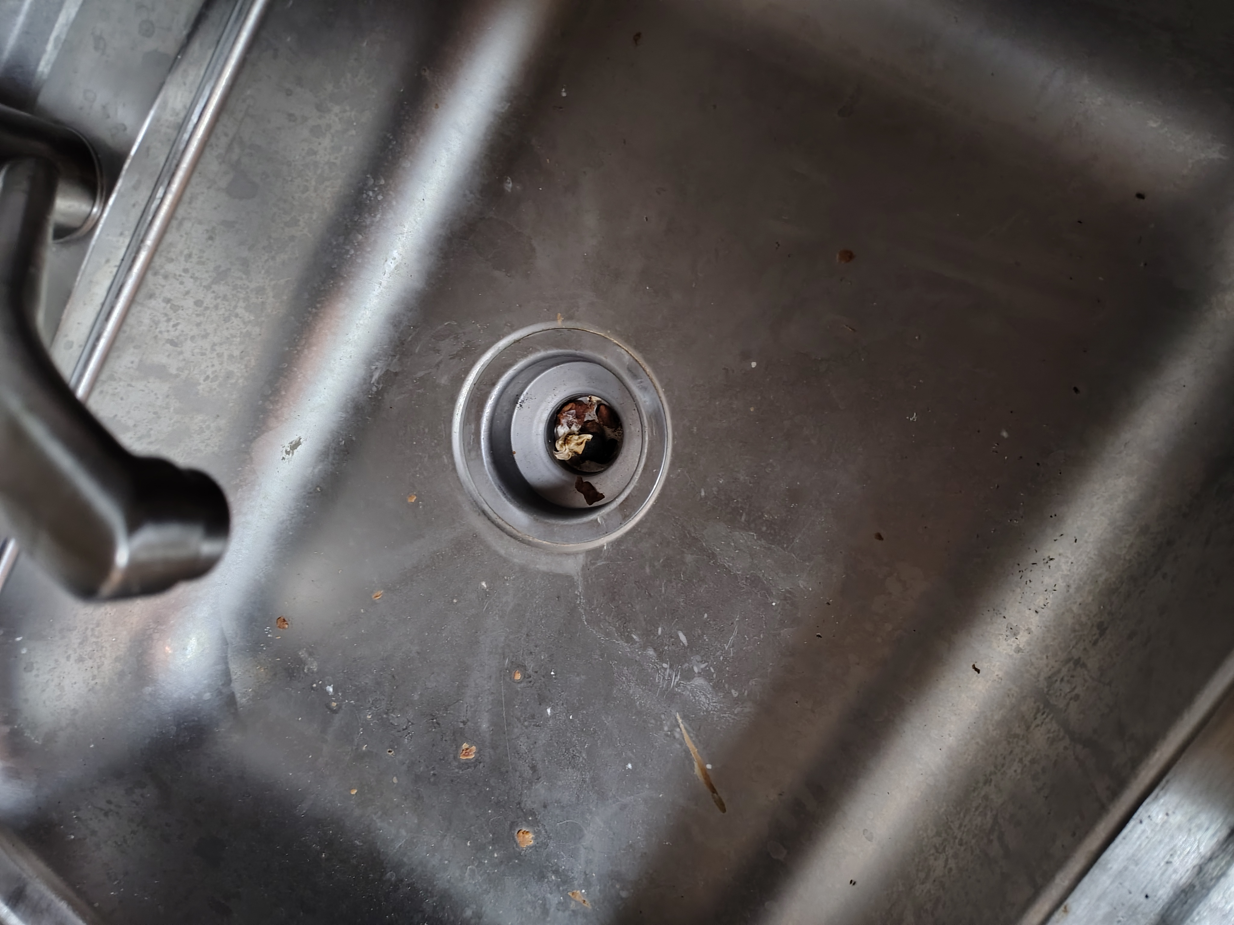Community Room stainless sink with debris in the drain