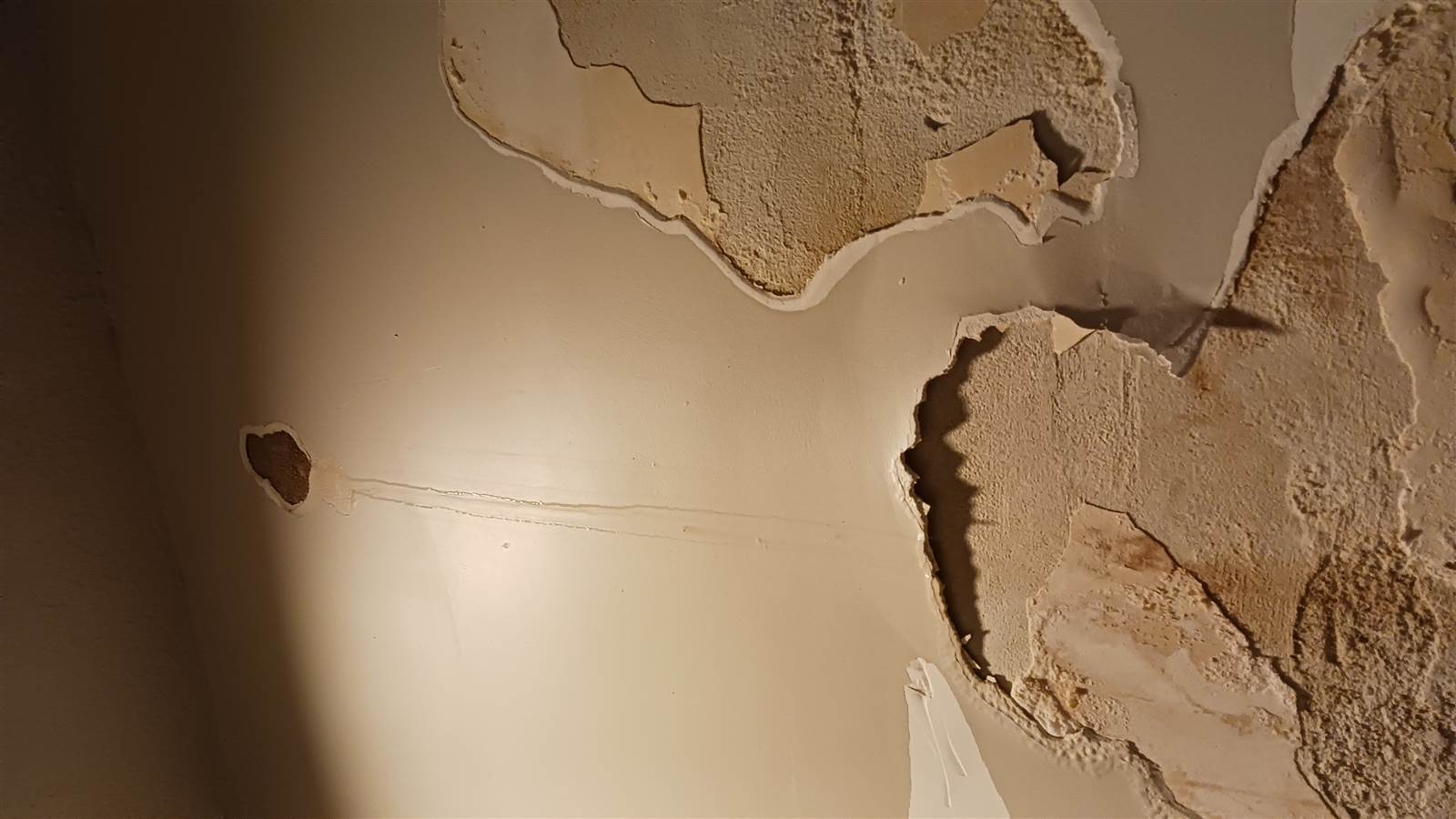 Peeling paint on the first-floor exit wall
