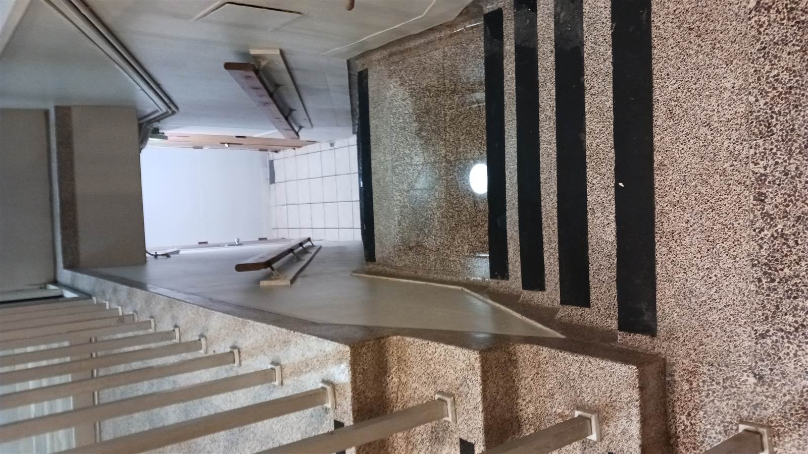Water at the lobby stair opening down to the basement