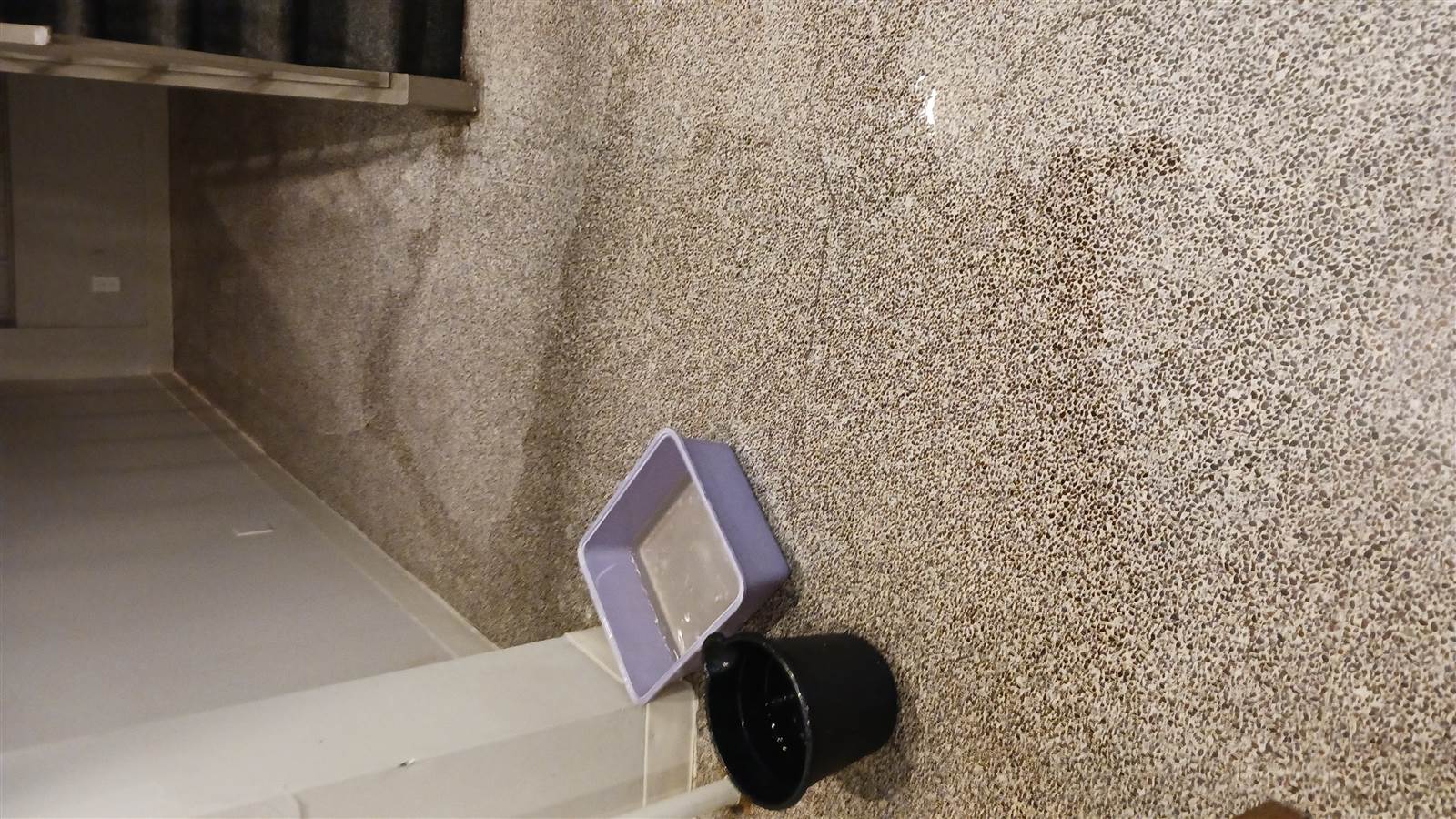 Lobby floor with buckets set out for water